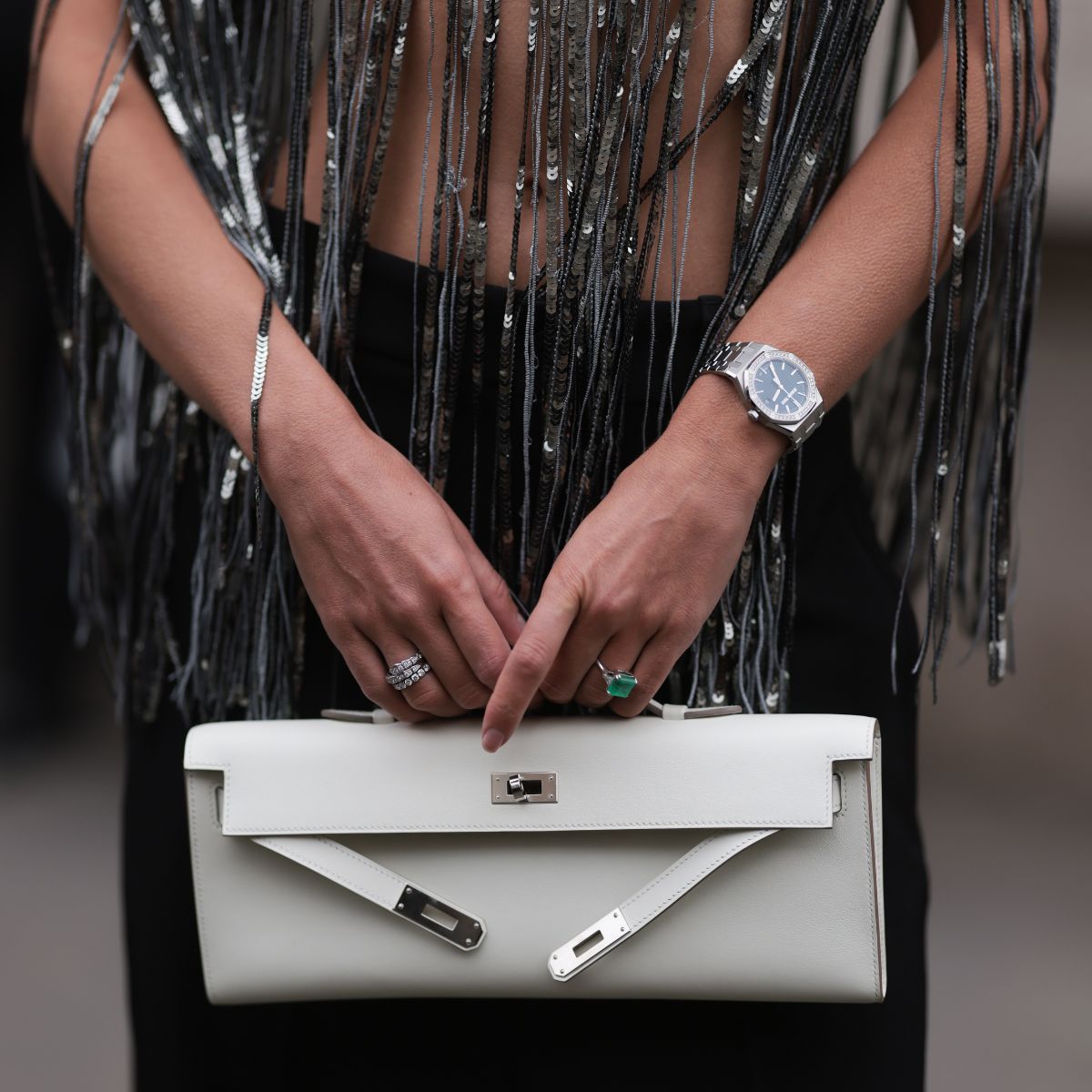 Elegant fitness trackers: A woman holding a handbag with a watch on