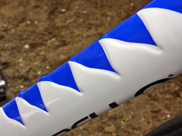 The blue swatches on the down tube are meant to highlight the surface shaping - which is presumably there to reduce aerodynamic drag.