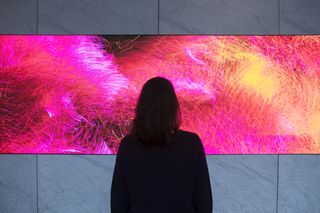 Lobby visitors often get lost in the virtual art and look for meaning behind the changing patterns.