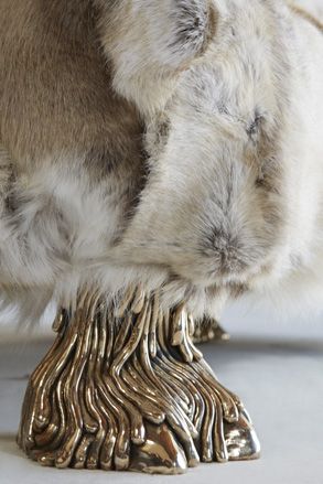 The sofa's cast bronze camel toe feet