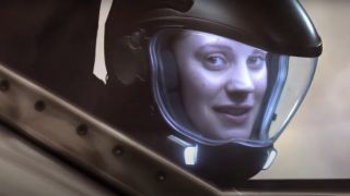 Katee Sackhoff smiling in a Viper cockpit in Battlestar Galactica.