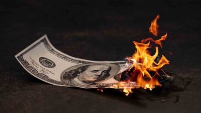 A $100 bill is on fire