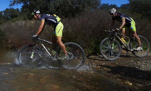 Teammates Ralph N&auml;f and Jos&eacute; Antonio Hermida cross a stream on stage 1 of the Andalucia Bike Race