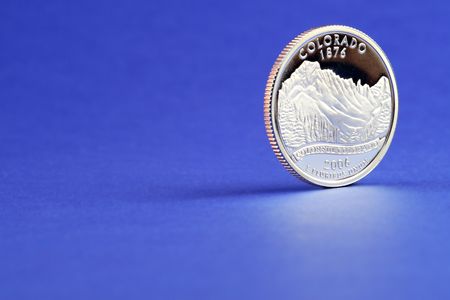 Colorado quarter on a bright blue background