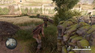 Sneaking through grass towards an unaware enemy in Sniper Elite: Resistance