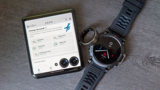 The Amazfit Helio Ring next to the T-Rex Pro and Razr Plus 2024 with the Zepp app open