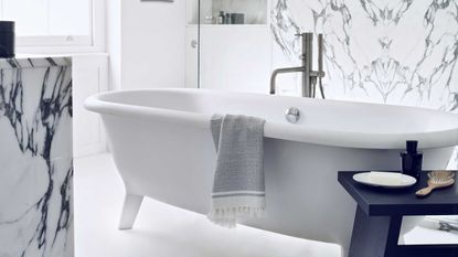 white and marble bathroom with freestanding tub