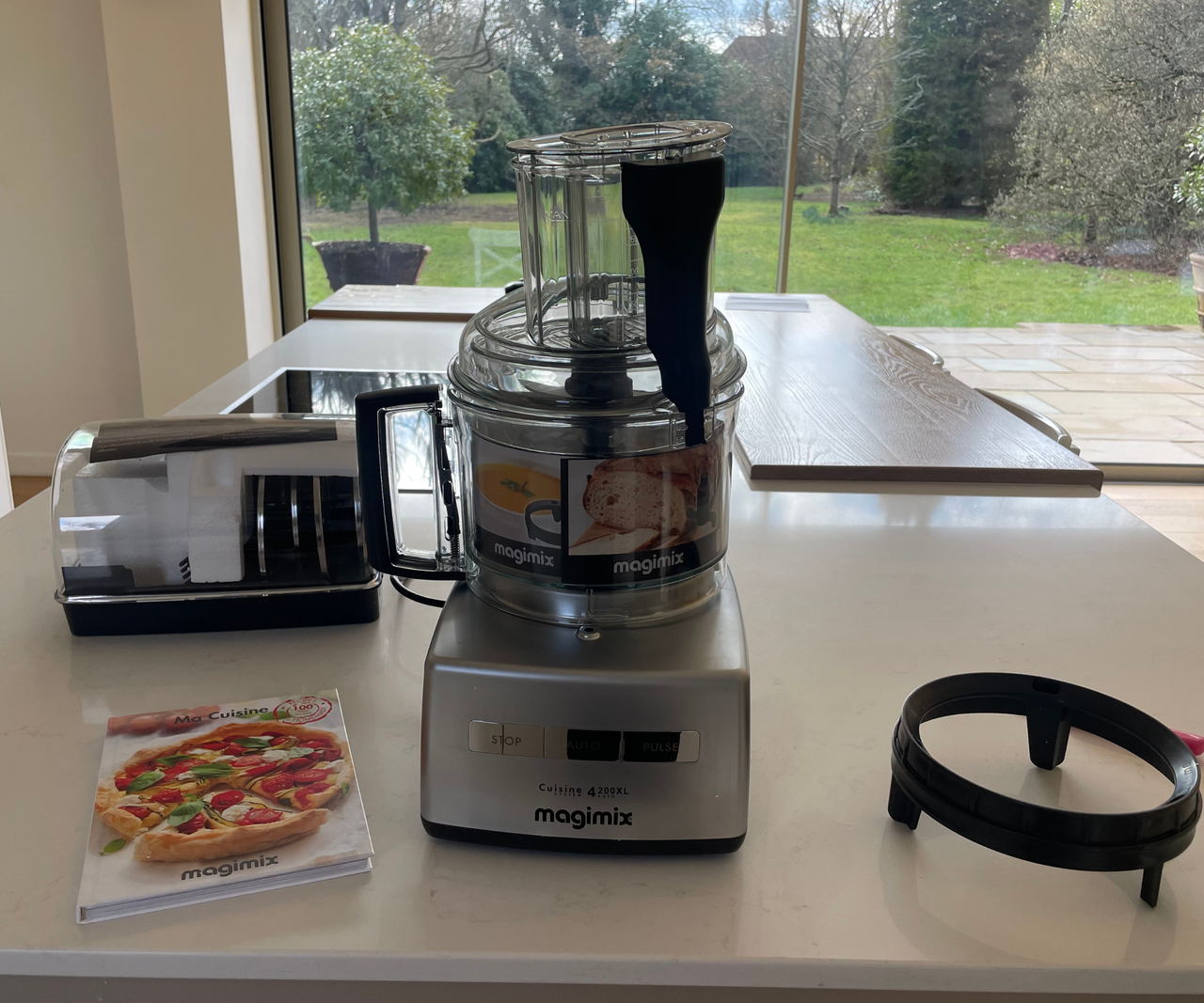 An unboxed Magimix 4200XL Food Processor on a white kitchen counter.