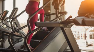 Woman climbing on a stairmaster machine