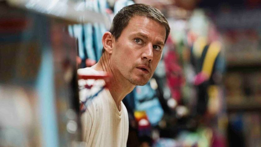 Channing Tatum peers out of a kids toy aisle 