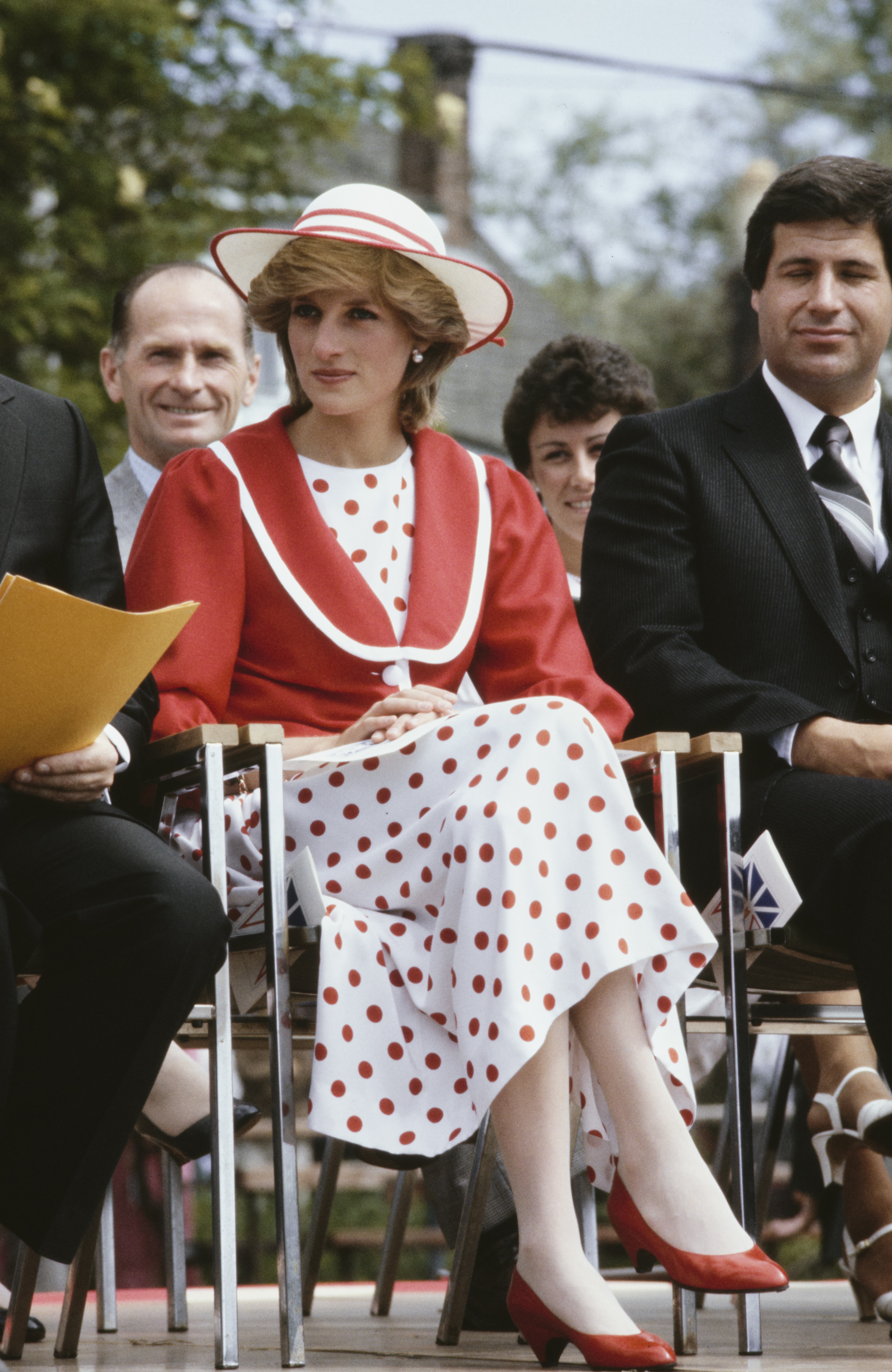 Diana, Princess of Wales wearing a red and white polka dot dress with a red jacket and a hat by John Boyd, whilst attending the Festival of Youth at the King George V Park in St John