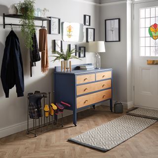 hallway with wooden drawer cabinet wool rich runner and iron wall shelf