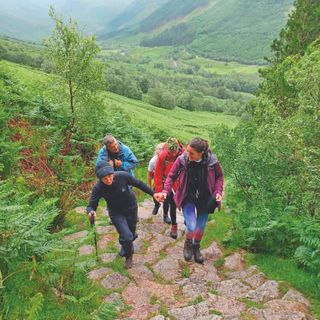 The three women hiking towards a peak