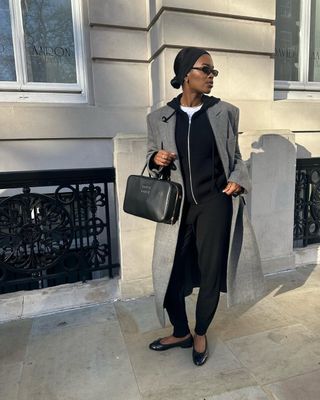 Fashion influencer @nlmarilyn wearing a chic travel outfit.