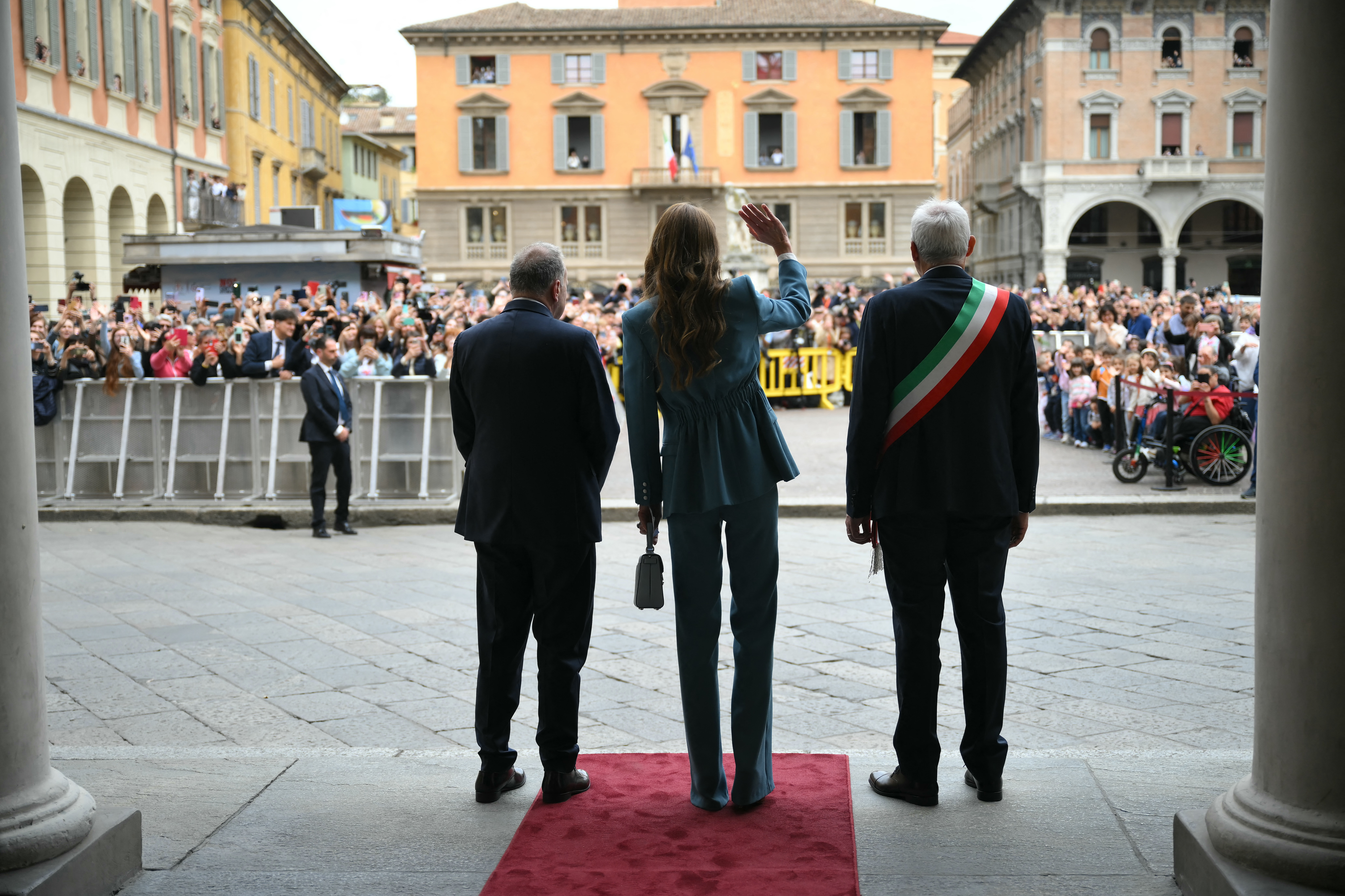 Britain's Catherine, Princess of Wales waves to the crowd as she is welcomed by the mayor of Reggio Emilia, Marco Massari (Photo by Marco BERTORELLO / POOL / AFP)