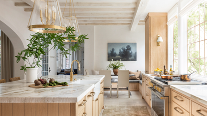 Oak kitchen with marble countertop and seating