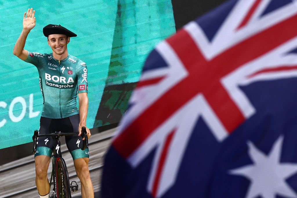 BORA hansgrohes Australian rider Jai Hindley waves on stage during the official teams presentation near the Guggenheim Museum Bilbao in Bilbao northern Spain on June 29 2023 two days prior to the start of the 110th edition of the Tour de France cycling race Photo by AnneChristine POUJOULAT AFP Photo by ANNECHRISTINE POUJOULATAFP via Getty Images