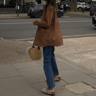 Influencer wears a brown suede jacket.