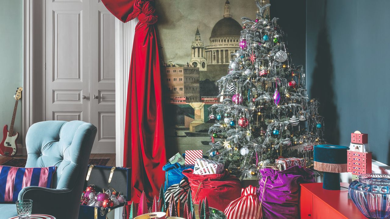 A living room with a decorated Christmas tree surrounded by colourful bags of presents