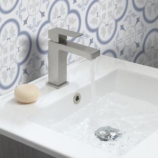 White bathroom sink with single mixer chrome tap