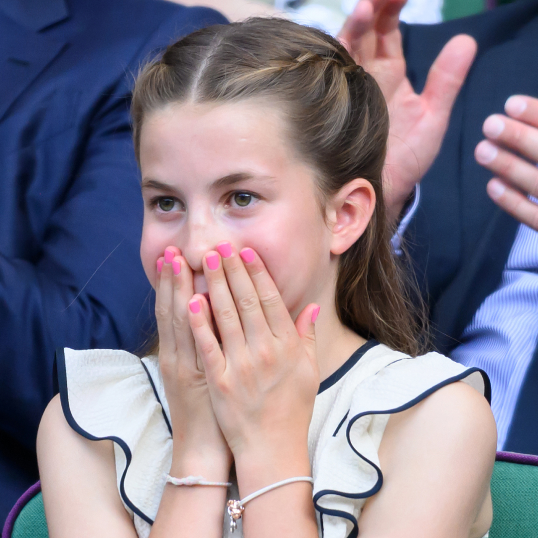 Princess Charlotte wearing pink nail polish at Wimbledon with her hands over her mouth