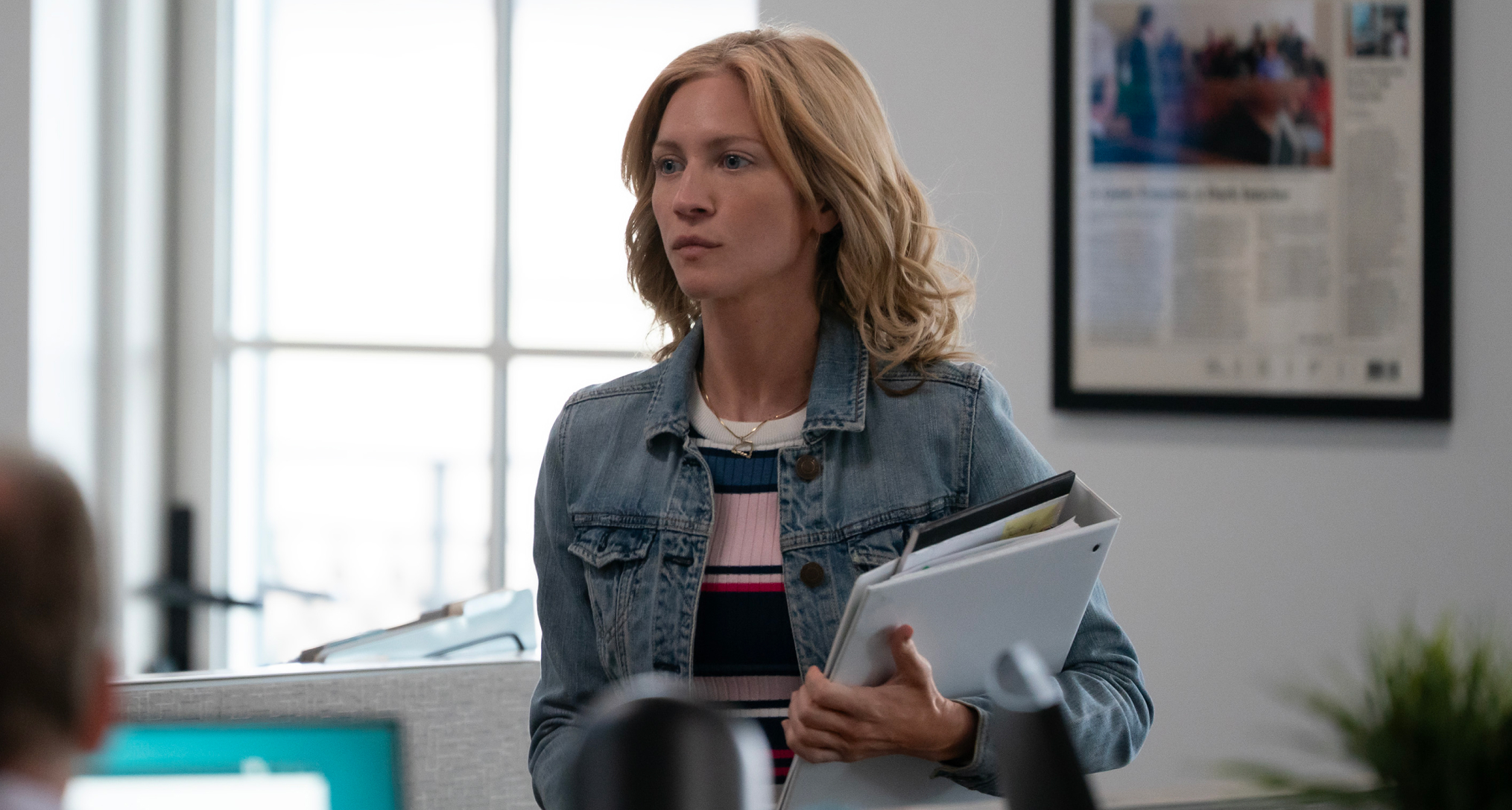 brittany snow as mandy matney holding binders walking through a newsroom in murdaugh death in the family