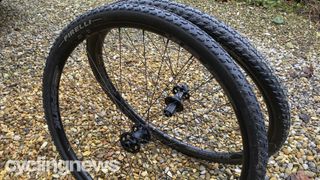 A pair of black Spank wheels and tyres on a gravel driveway