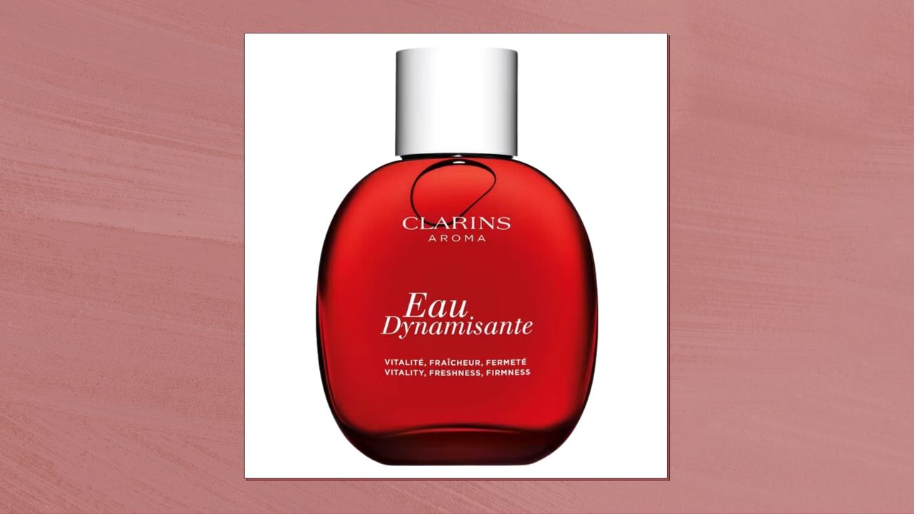 A product shot of Clarins Eau Dynamisante, on a white background and featured in a dark pink template