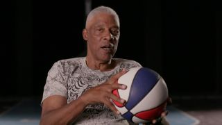 Julius "Dr. J" Erving holding an red, white, and blue ABA basketball in Soul Power