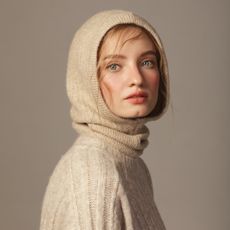 young woman wearing knitted hood - best products for hair loss