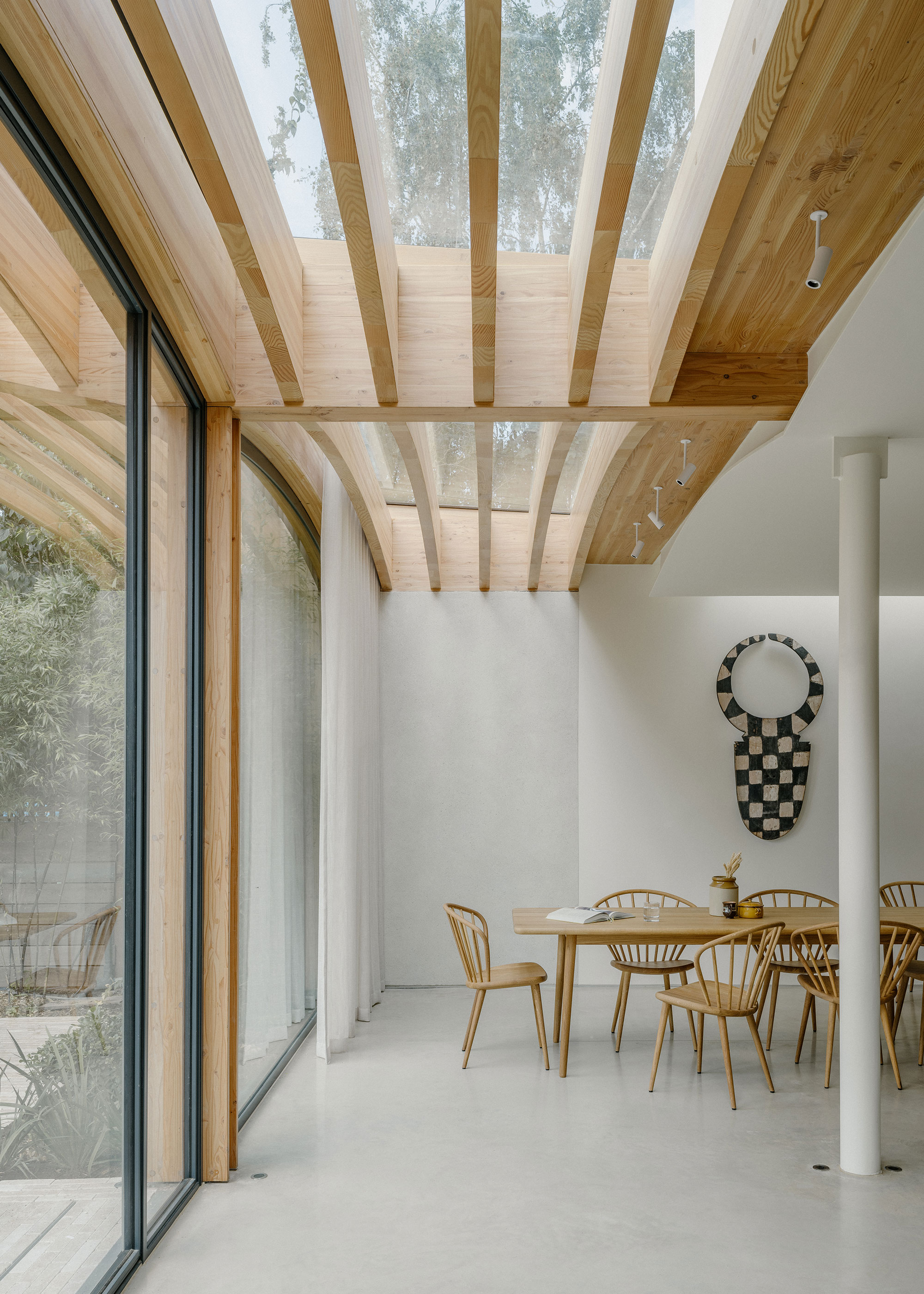 modern open plan dining space with slatted timber and glass ceiling