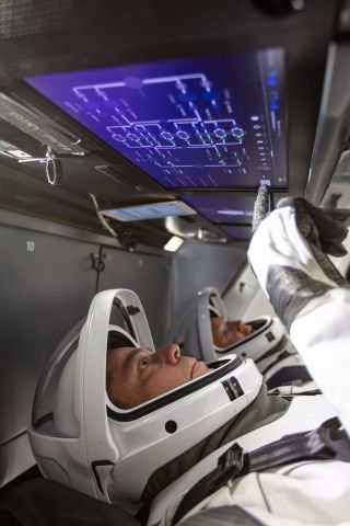 NASA astronauts Bob Behnken (foreground) and Doug Hurley familiarized themselves with SpaceX's Crew Dragon over the two years spanning their Demo-2 crew selection and the launch of the mission.