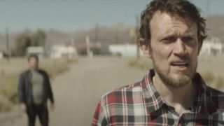 Chad Villella and Matt Bettinelli-Olpin of Radio Silence standing on a desert road in Southbound