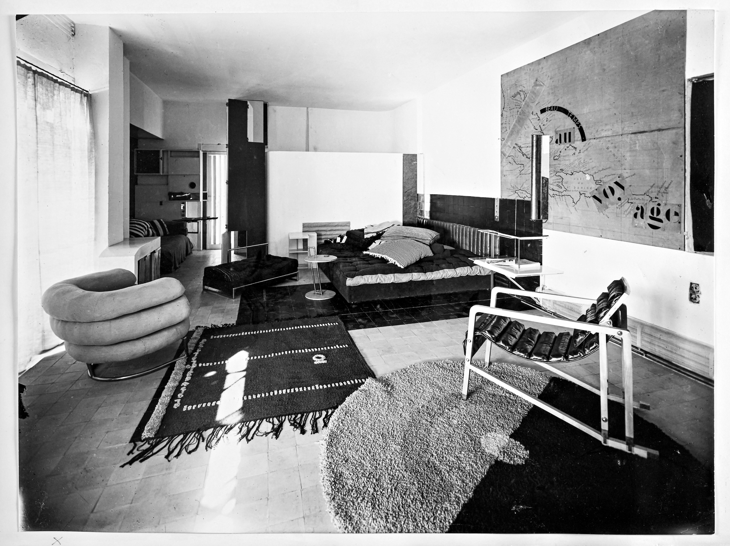 a vintage photo of a living room with a bibendum chair taken by eileen gray