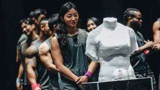 Members of the Physical: 100 season 1 cast stood next to their physique sculptures