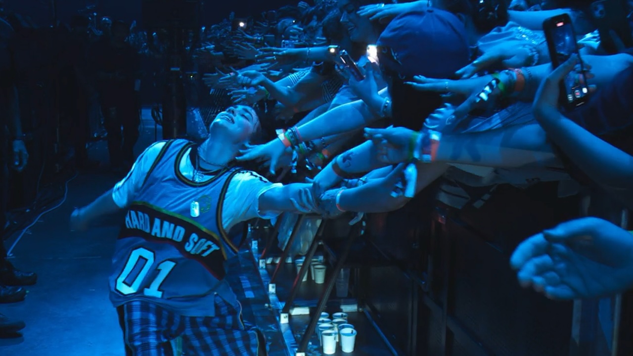 Billie Eilish leaning back, being touched by fans in Billie Eilish Hit Me Hard And Soft The Tour (Live in 3D)