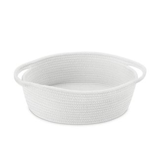 A white woven storage basket with handles