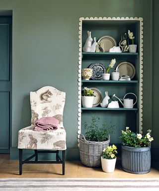 wall with wooden shelving with easter decor and upholstered chair
