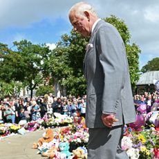 King Charles III views tributes outside Southport Town Hall, during his visit to meet with members of the local community, following the July 29 attack at a children's' dance party on August 20, 2024 in Southport, England.