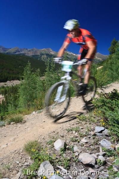 A rider flies down a descent during stage 4