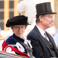 Princess Anne rides in a carriage with husband Sir Timothy Laurence
