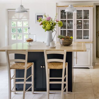 dresser in kitchen behind table and chair