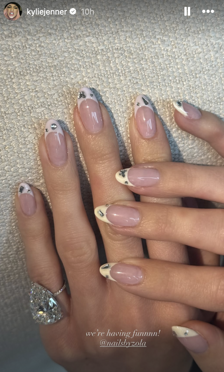 a french manicure with silver gems