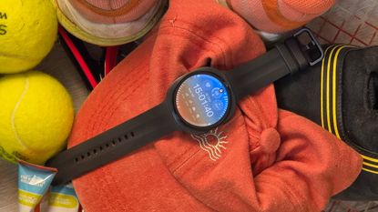 The Samsung Galaxy Watch 9 on a pile of sports kit.