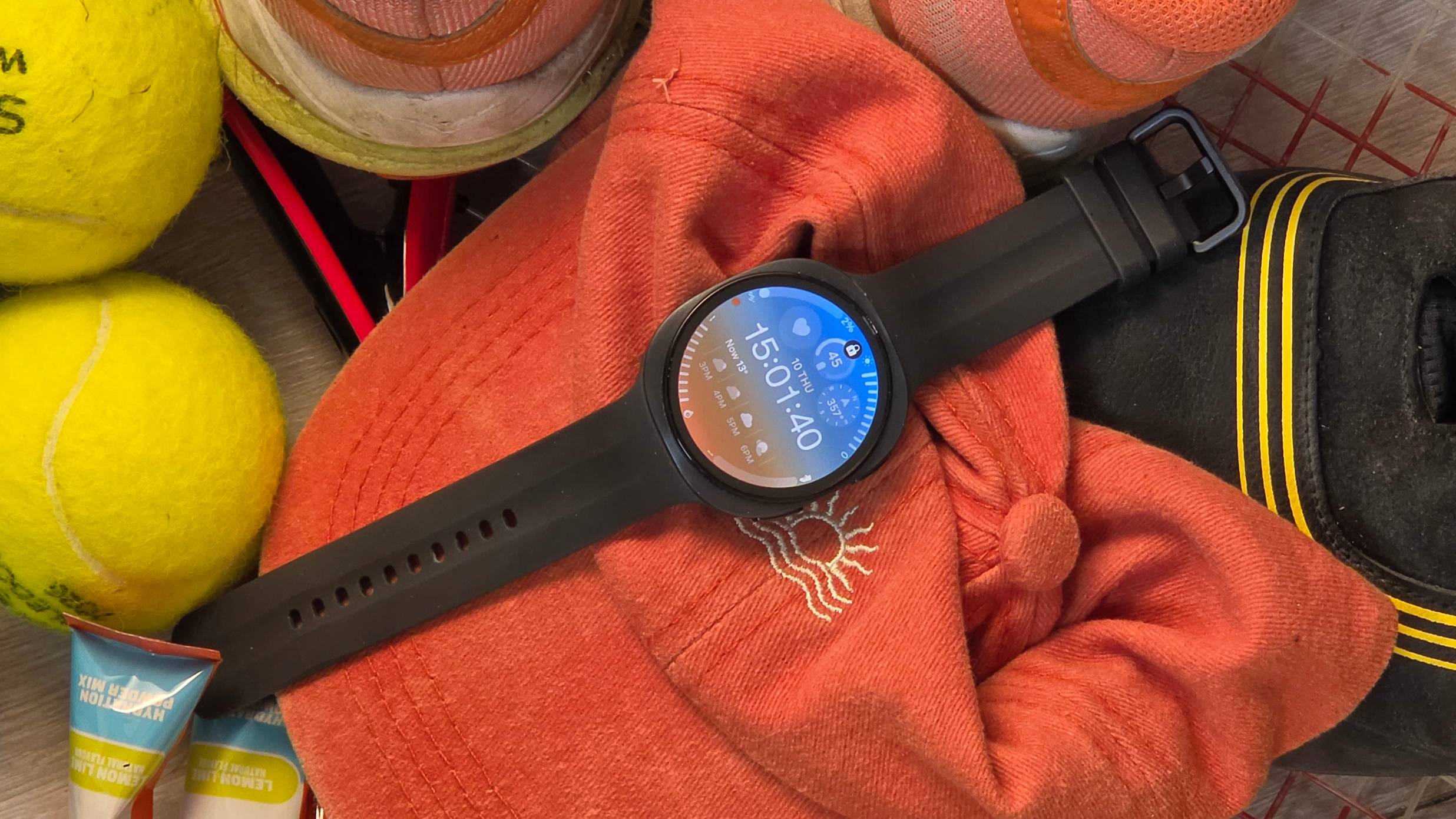 The Samsung Galaxy Watch 9 on a pile of sports kit.