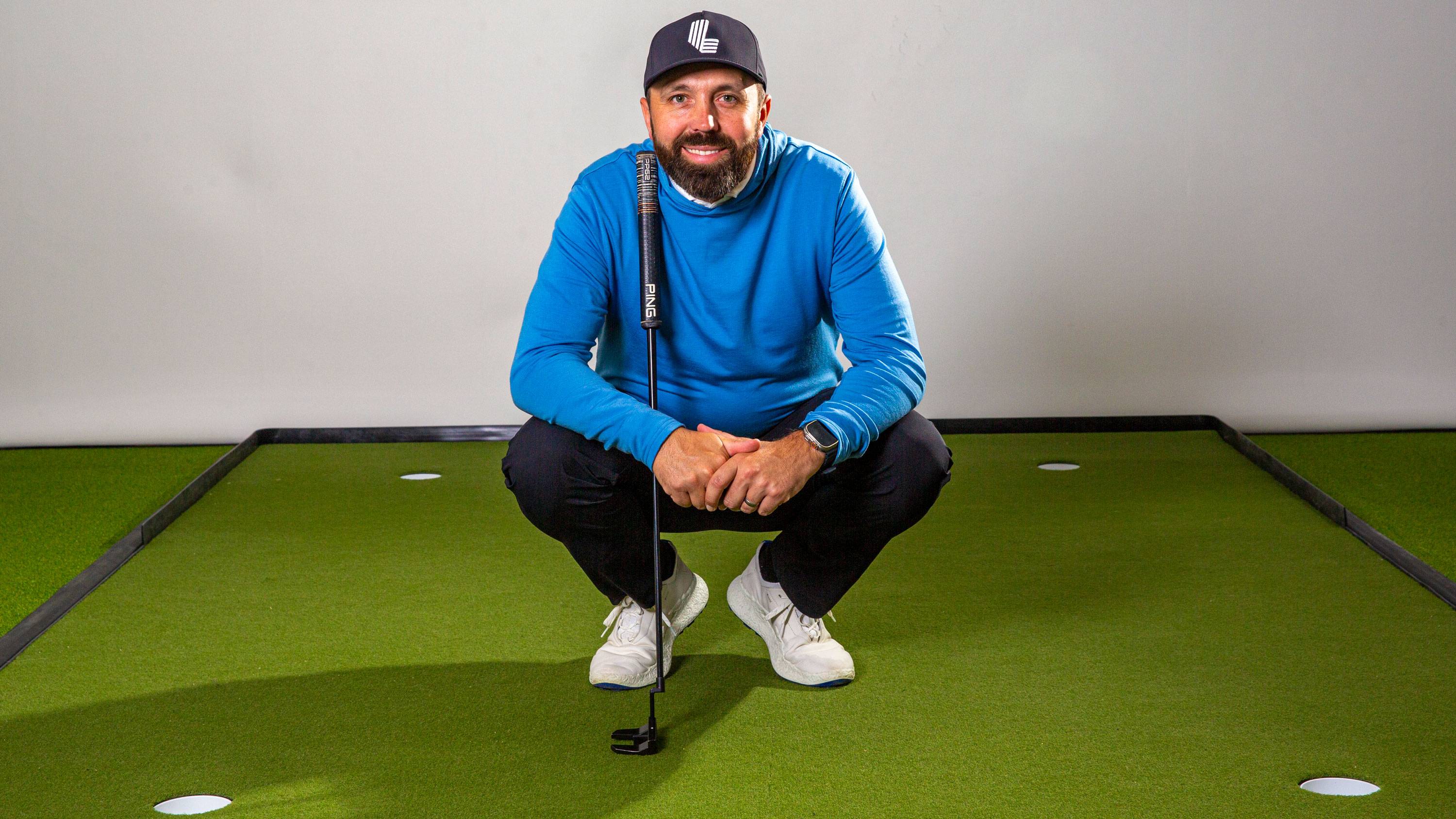 Rick Shiels poses in his putting studio
