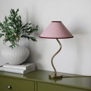 M&S Hallie table lamp on a green sideboard with a vase of foliage next to it