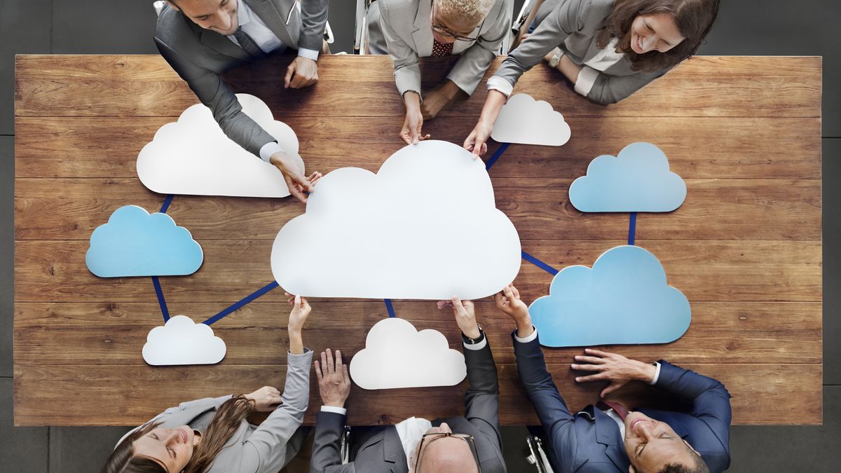 crowd of people around table with clouds