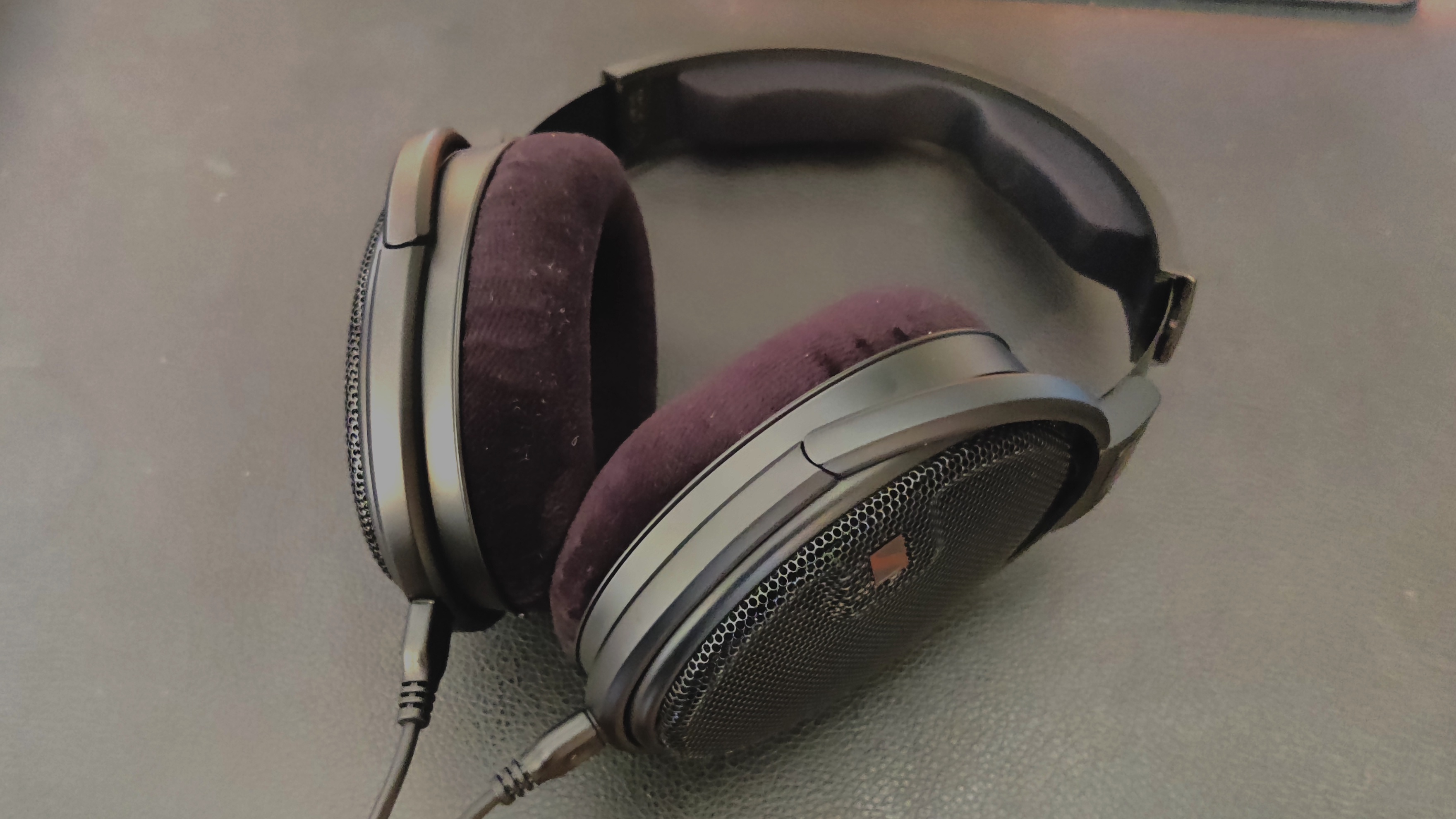 The Sennheiser HD-660S2 headhphones pictured on a wooden surface.