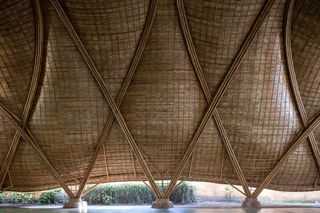 Interior of roof structure with diamond shape bamboo structures.